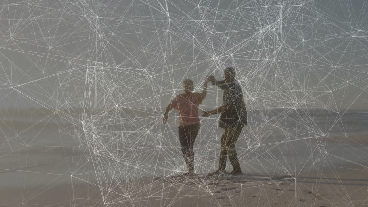 couple dancing barefoot on beach, illustrating technology network overlay with data nodes