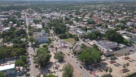 Arc-of-triumph-at-San-Juan-de-la-Maguana-with-cityscape,-Dominican-Republic