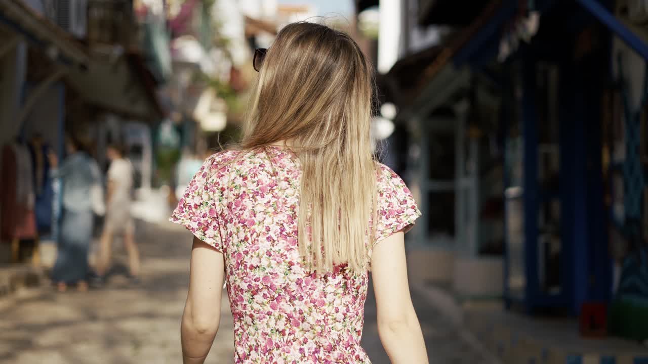 Girl wondering around old town with shop's showcases