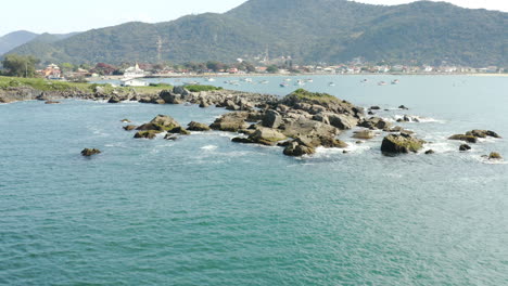 rocky coastline with turquoise colored water, praia armacao, florianopolis, santa catarina, brazil