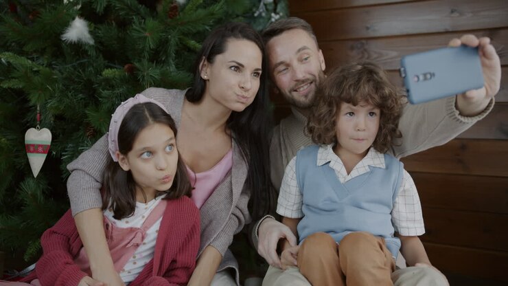 Family Selfie by the Christmas Tree