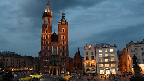 time lapse view of the st. mary's basilica at dusk with evening lights in the city of krakow