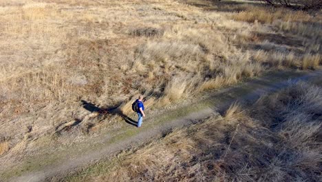 Mature-man-hiking-is-lost-and-can't-get-a-cell-mobile-phone-signal---aerial-orbit-view