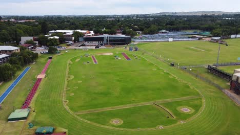 an aerial of an athletic sports field in south africa, lookin green and lush