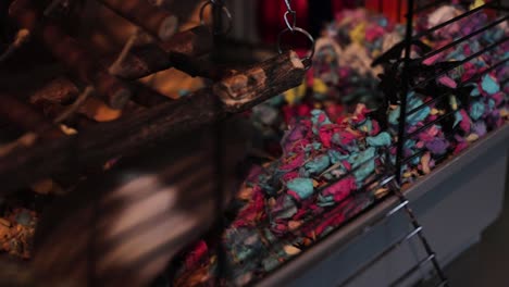 a cute hamster uses animal bedding to build her own house inside a cage.