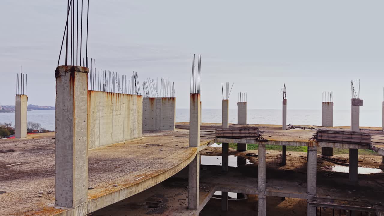 Construction site with concrete pillars overlooking a serene landscape