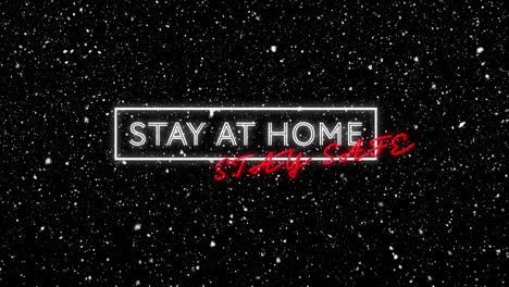 animation of stay at home stay safe text with winter scenery and snow falling on black background