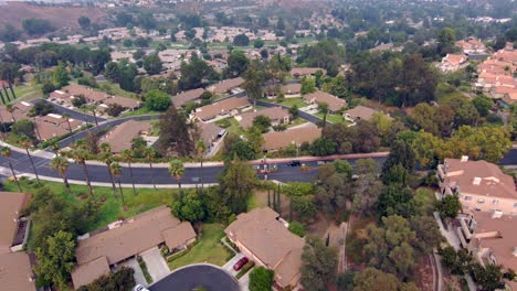 community of houses, suburb neighborhood, pull back rising aerial view