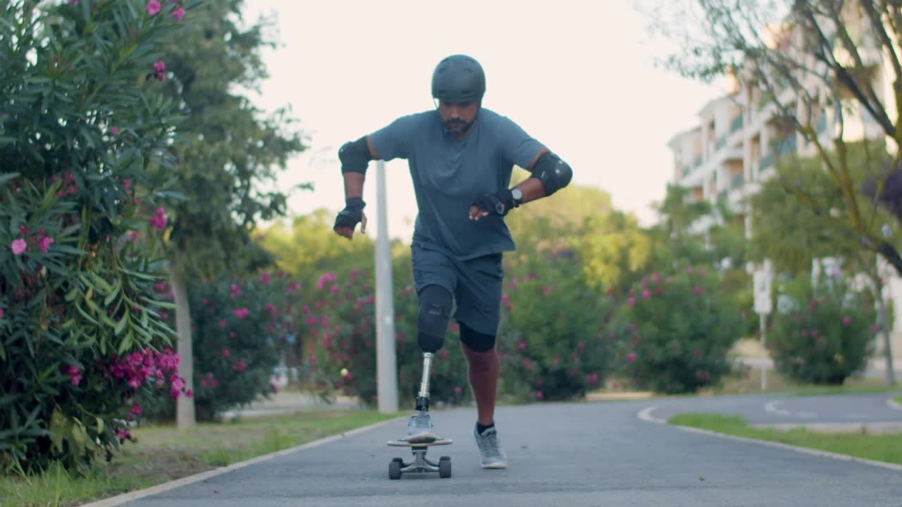 Mid adult man with prosthetic leg skating on board in park