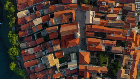 aerial: top down view of korčula old town rooftops, croatian tourist destination