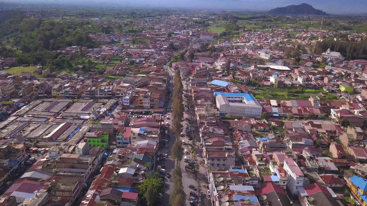 Aerial View of a Town in Indonesia with Mountains in the Background