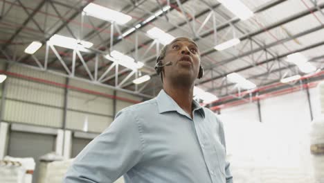 close up of a male warehouse worker using headset in a storeroom 4k