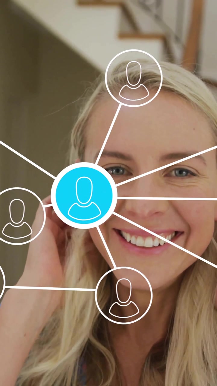 Smiling woman with network of connections animation over her in home setting