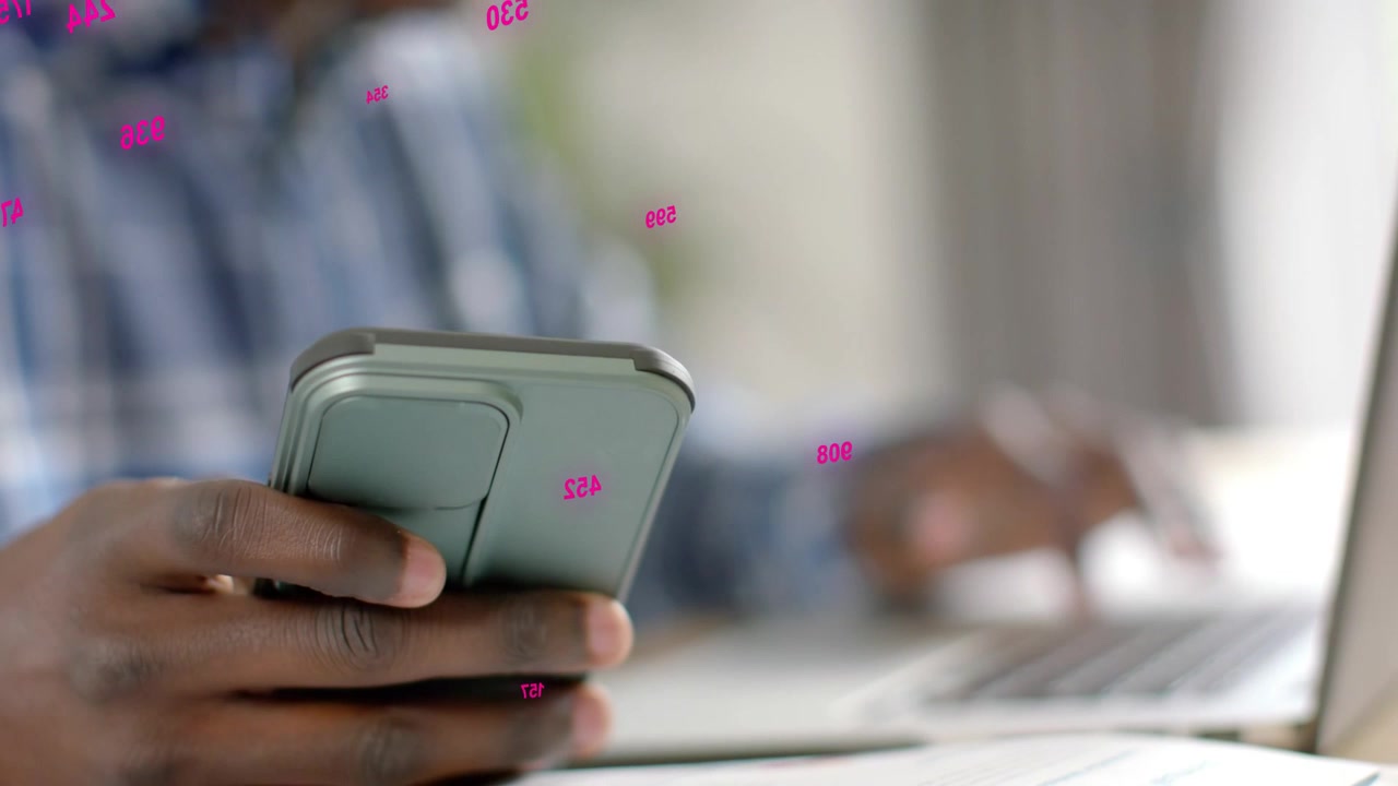 Man alternating tapping smartphone and typing laptop for tech work, pink graphics reacting to taps