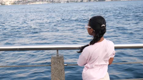 a girl looking at the ocean