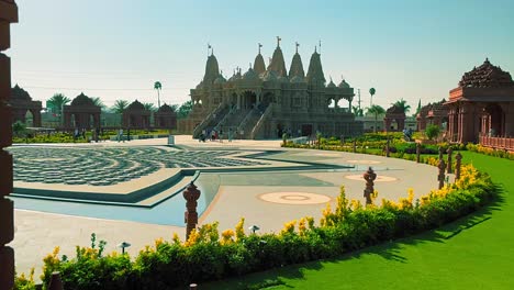 panning right ground shot looking at the front of the baps shri swaminarayan mandir hindu temple in chino california