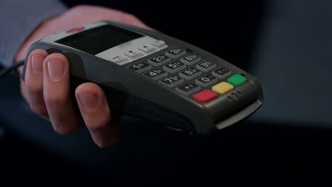 nfc terminal payment. hand of customer paying contactless credit card