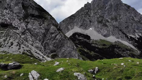 Aerial-of-Austrian-Alps-Drachensee-mountain-rolling-over-hill