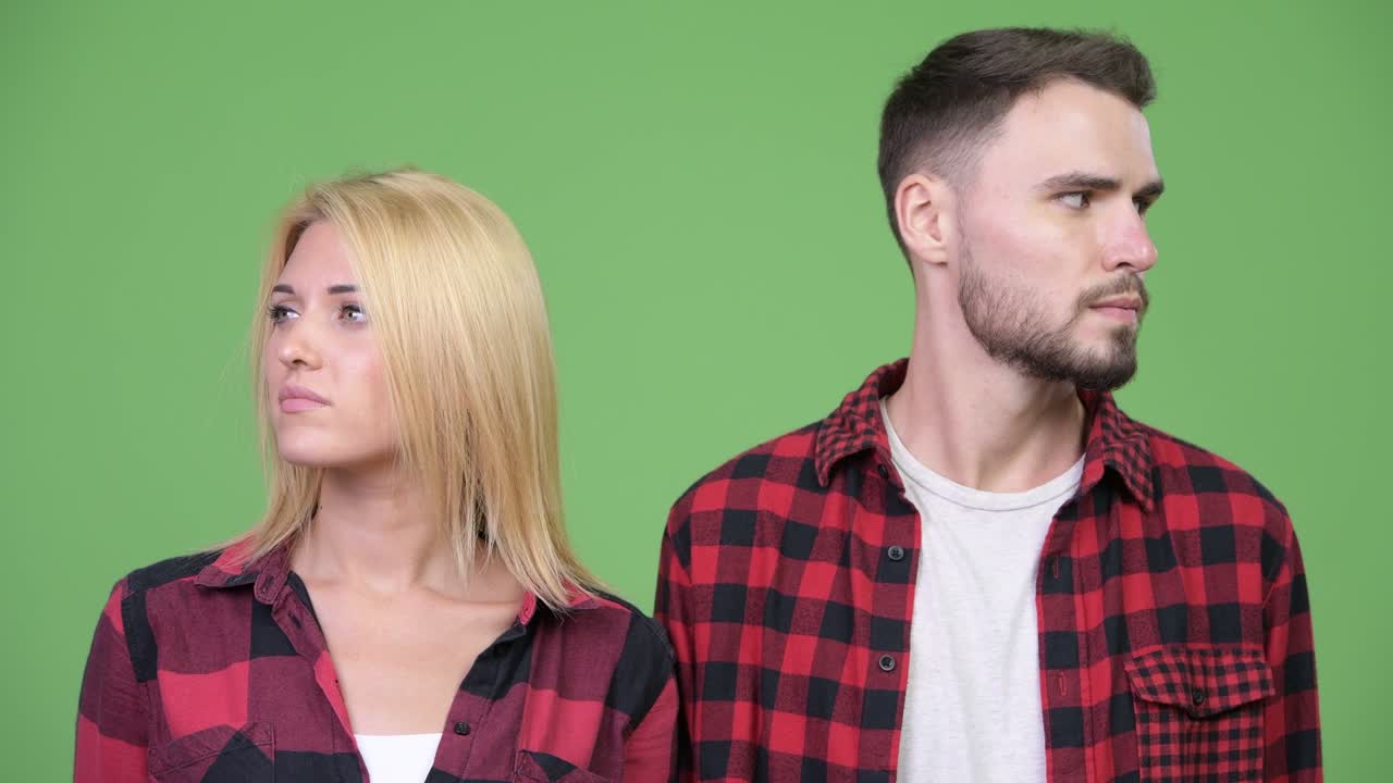 Young couple facing on different directions together