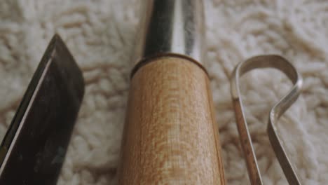 craftsman's tools on knitted cloth. macro, sliding down