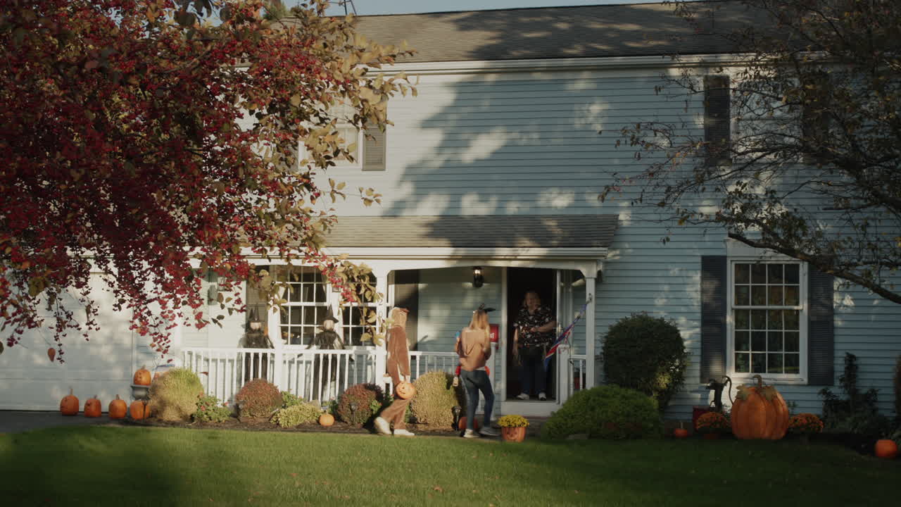 Children in festive costumes go for candy on Halloween day