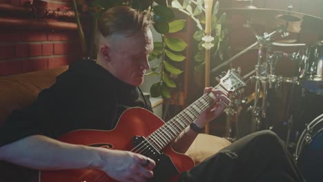 man playing jazz guitar in home studio