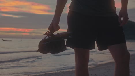 videographer at sunset beach