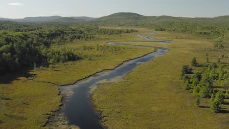 Spectacular-aerial-view-ascending-over-lust-green-Union-River,-Eastern-Maine-scenery