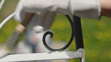 painting rusty chair with protective anti-rust paint