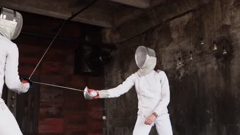 two fencers in a competition