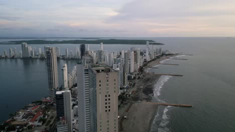 aerial along the playa de bocagrande beaches and skyscrapers at dusk in cartagena, boliviar, colombia