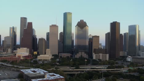 high angle drone view of downtown houston, texas and surrounding landscape