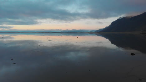 volcanic stokksnes mountains reflected in icelandic icy seascape aerial view