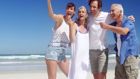 Happy-family-taking-selfie-from-mobile-phone-at-beach