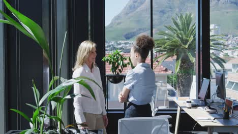 two women talking near the window