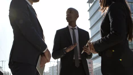 coworkers shaking hands and discussing work