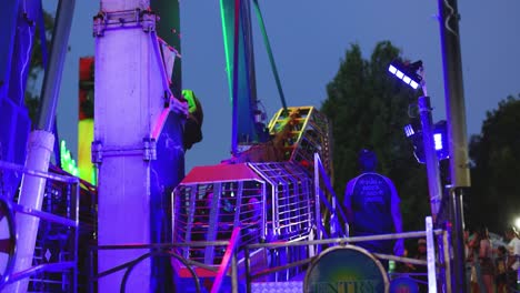 colorful ride moving at night with people