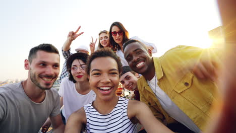 happy friends taking a selfie on a rooftop