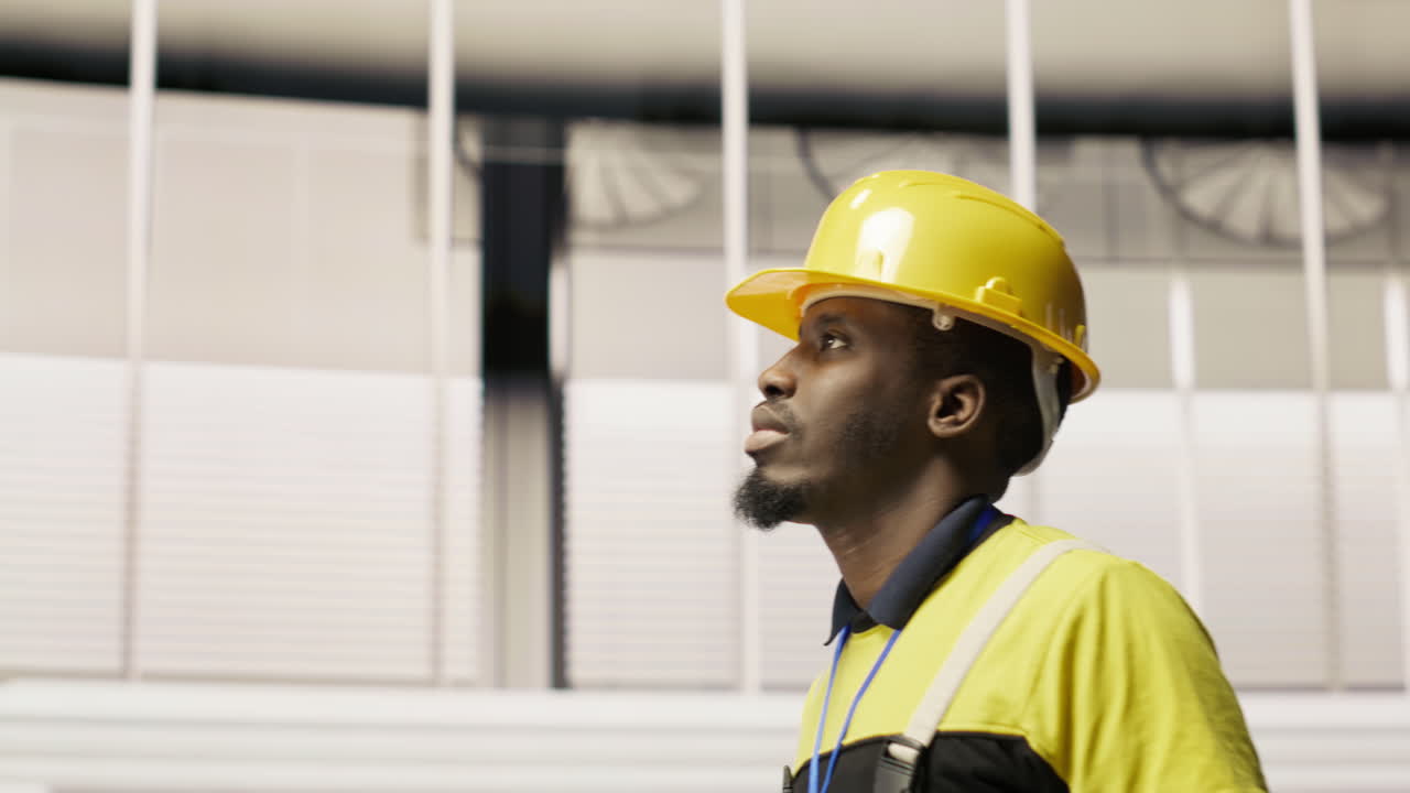 Vertical video Technician holding toolbox walking in factory, overseeing production lines