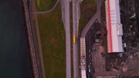 Yellow-bus-on-a-road-from-top-shot-aerial-view-in-Iceland