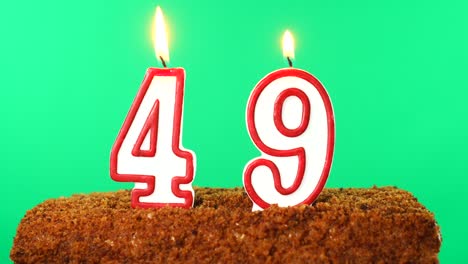 cake with the number 49 lighted candle. chroma key. green screen. isolated