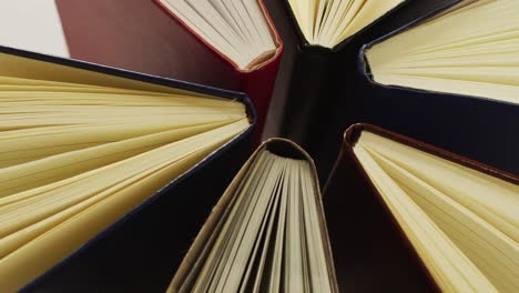 Video-of-composition-with-diverse-books-standing-on-brown-surface