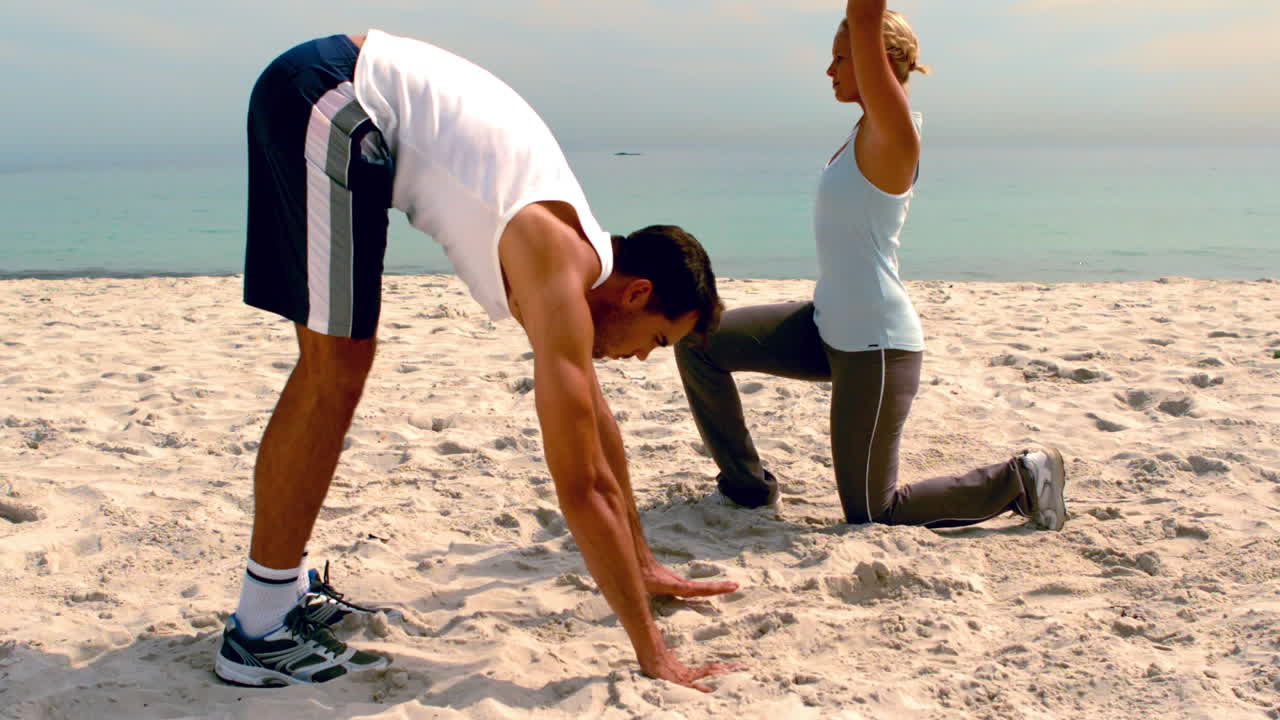Friends doing yoga on the beach together