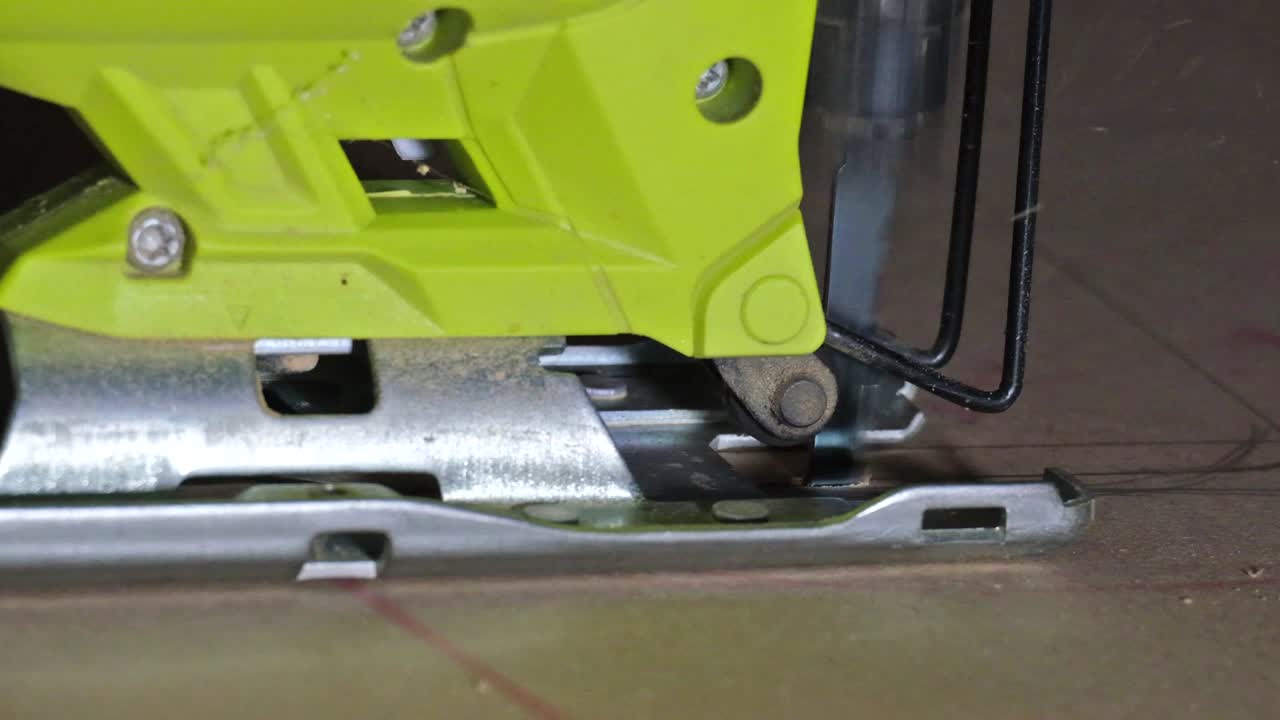 전기 직소 클로즈업, 남성의 손이 직소로 나무 판자를 슬로우 모션으로 절단