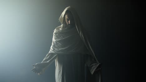 the resurrection of jesus christ. jesus praying, worshipping inside the tomb, in bright light, raising his hands in dramatic, cinematic slow motion. perfect for easter resurrection visual.