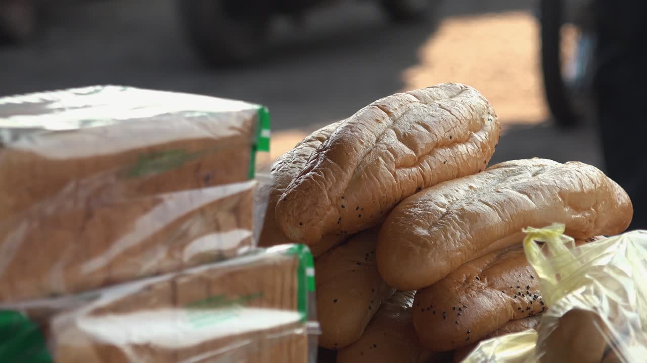 Close Interior Static Shot of Baguettes on a Food Stall on the Side of the Street in the Day