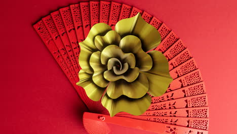 animation of chinese pattern and fan with copy space on red background