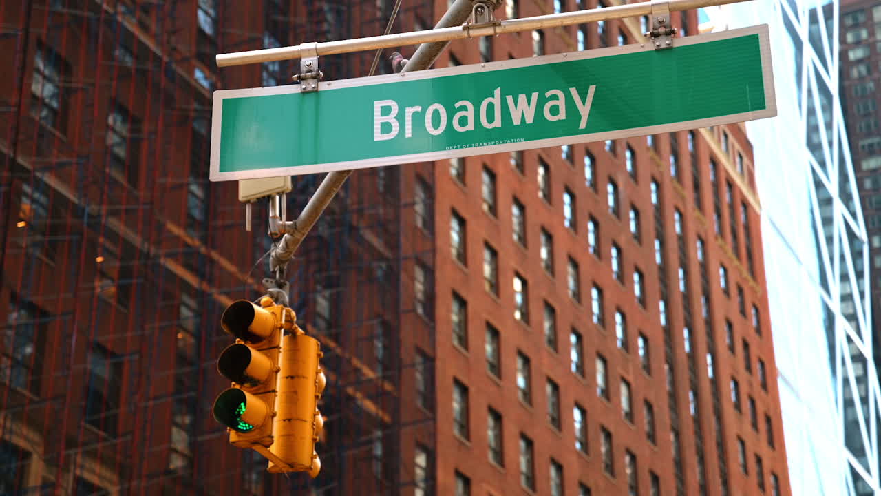 Broadway sign with traffic light in New York
