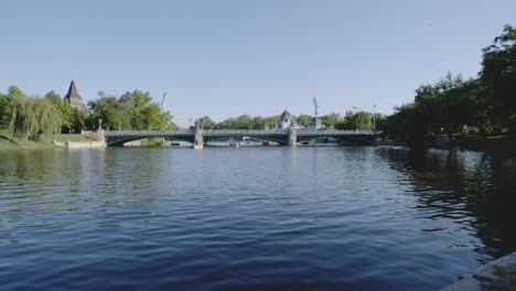 city park historical arches steel bridge over water, varosligeti lake budapest