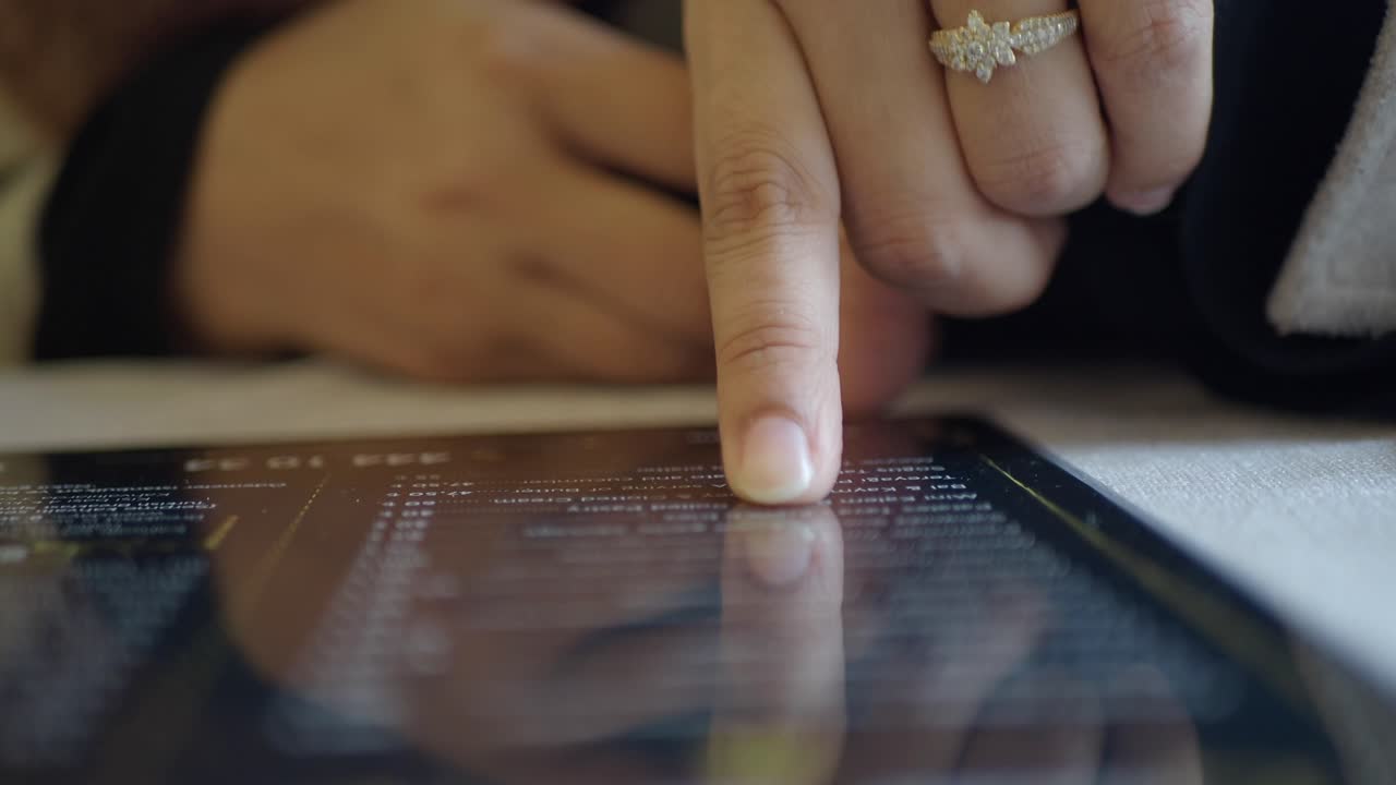 Person Using Tablet to Order Food from Menu